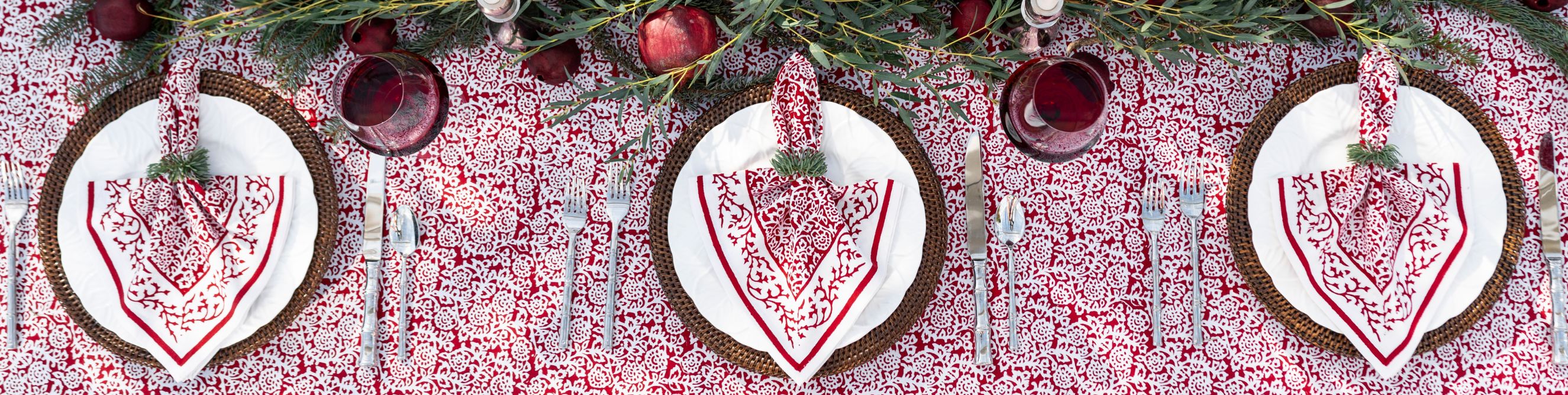 Model wearing Emma Crimson & Clover Apron setting table