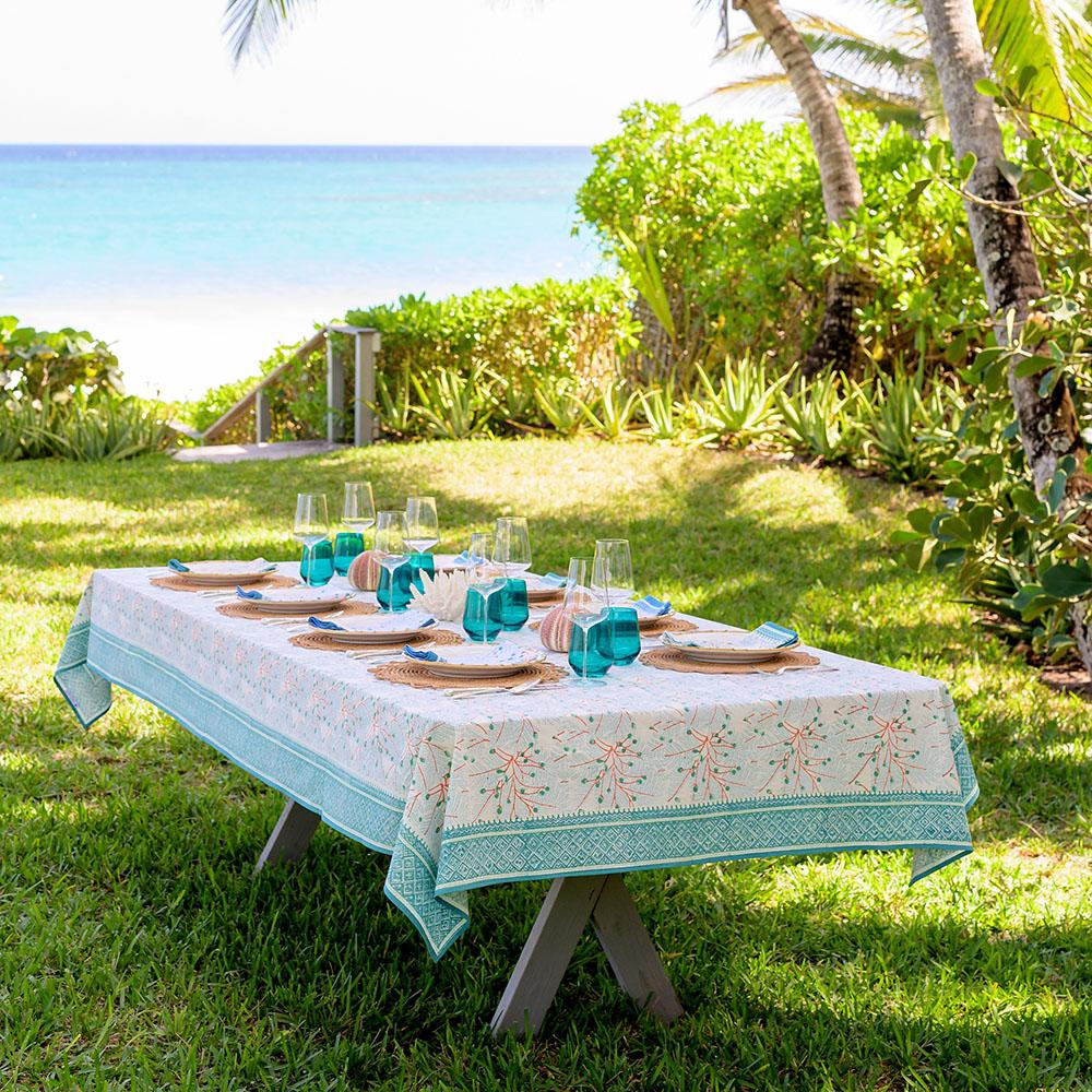 Teal & coral hand block printed cotton tablecloth set for dinner in a beach setting