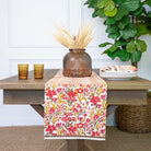 Garden Sunset table runner on a wood table with coordinating accents.