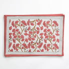 A set of placemats with a ginkgo leaf pattern in coral hues