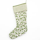 Quilted stocking with a holly print on a white background