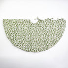 A quilted tree skirt with a festive Holly Berry design in shades of green and red.