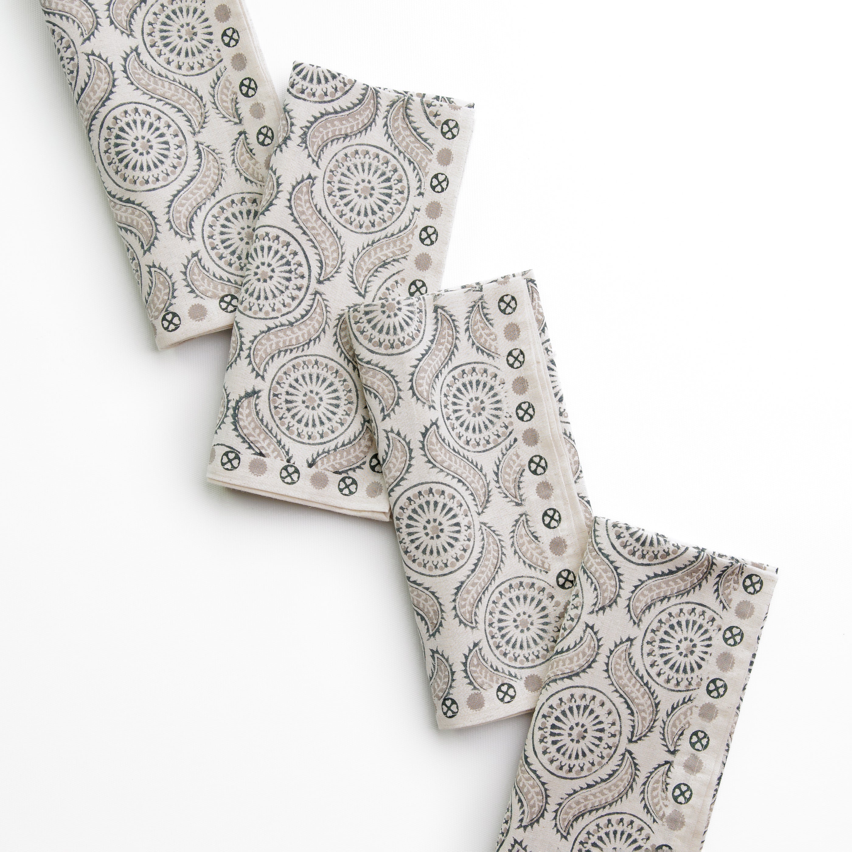 A set of folded cloth napkins with a geometric pattern, displayed on a white background