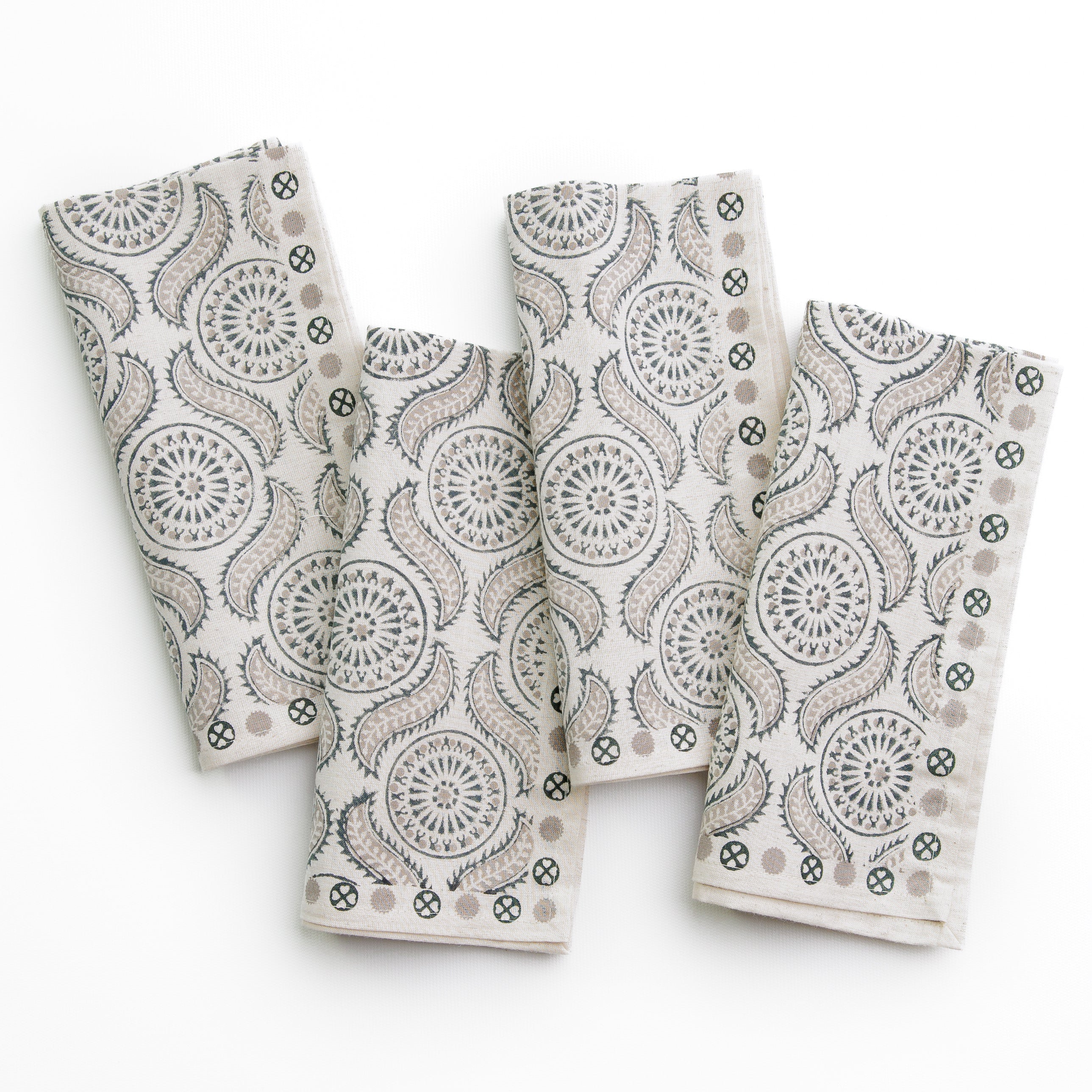 A set of folded cloth napkins with a geometric pattern, displayed on a white background