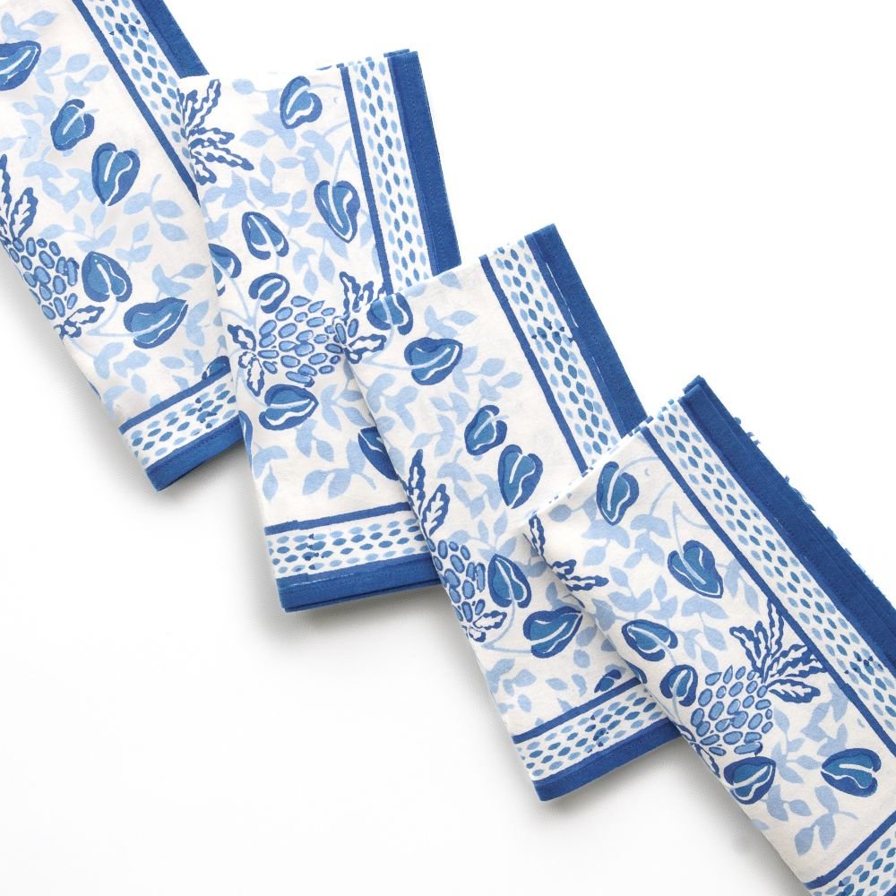 Set of blue and white patterned napkins on a white background