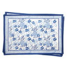 A set of blue and white placemats with a floral and pineapple pattern.