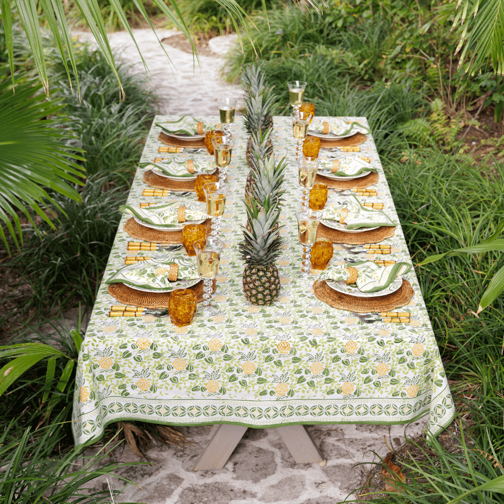 Dining table set with pineapple-themed decor outdoors