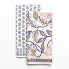 Two patterned tea towels with blue and orange designs on a white background