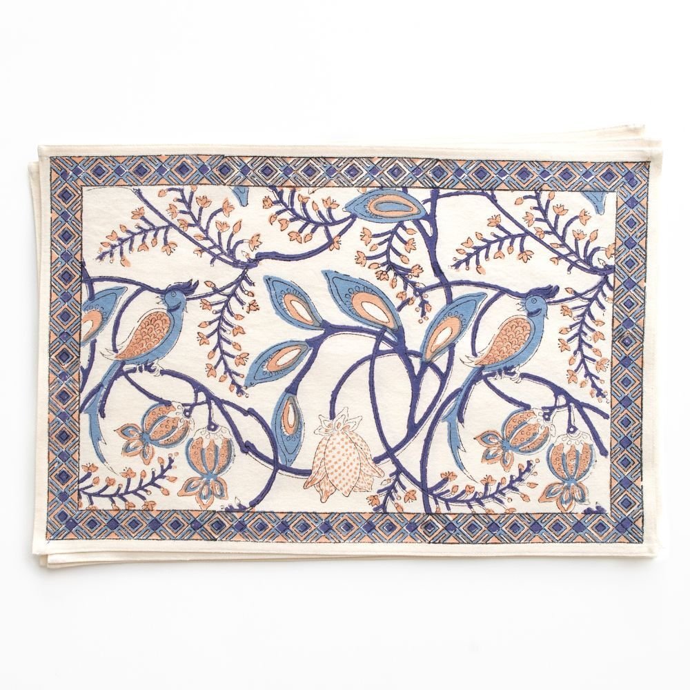 Decorative placemat with bird and floral pattern on a white background