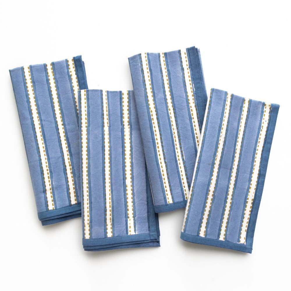 Set of four blue striped napkins on a white background