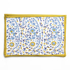 Floral patterned mat with yellow border on a white background