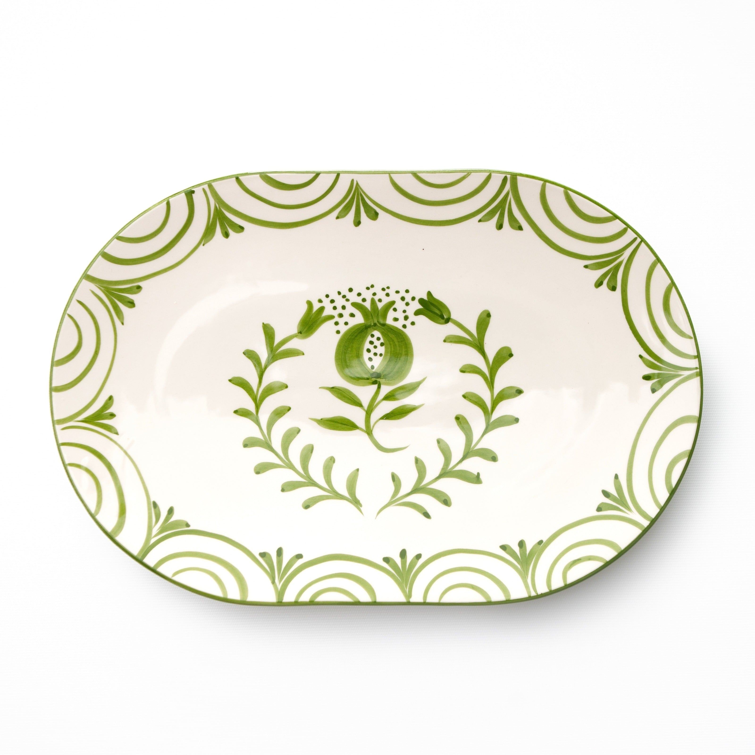 Decorative platter with green floral design on a white background