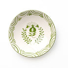 Decorative ceramic bowl with green floral design on a white background