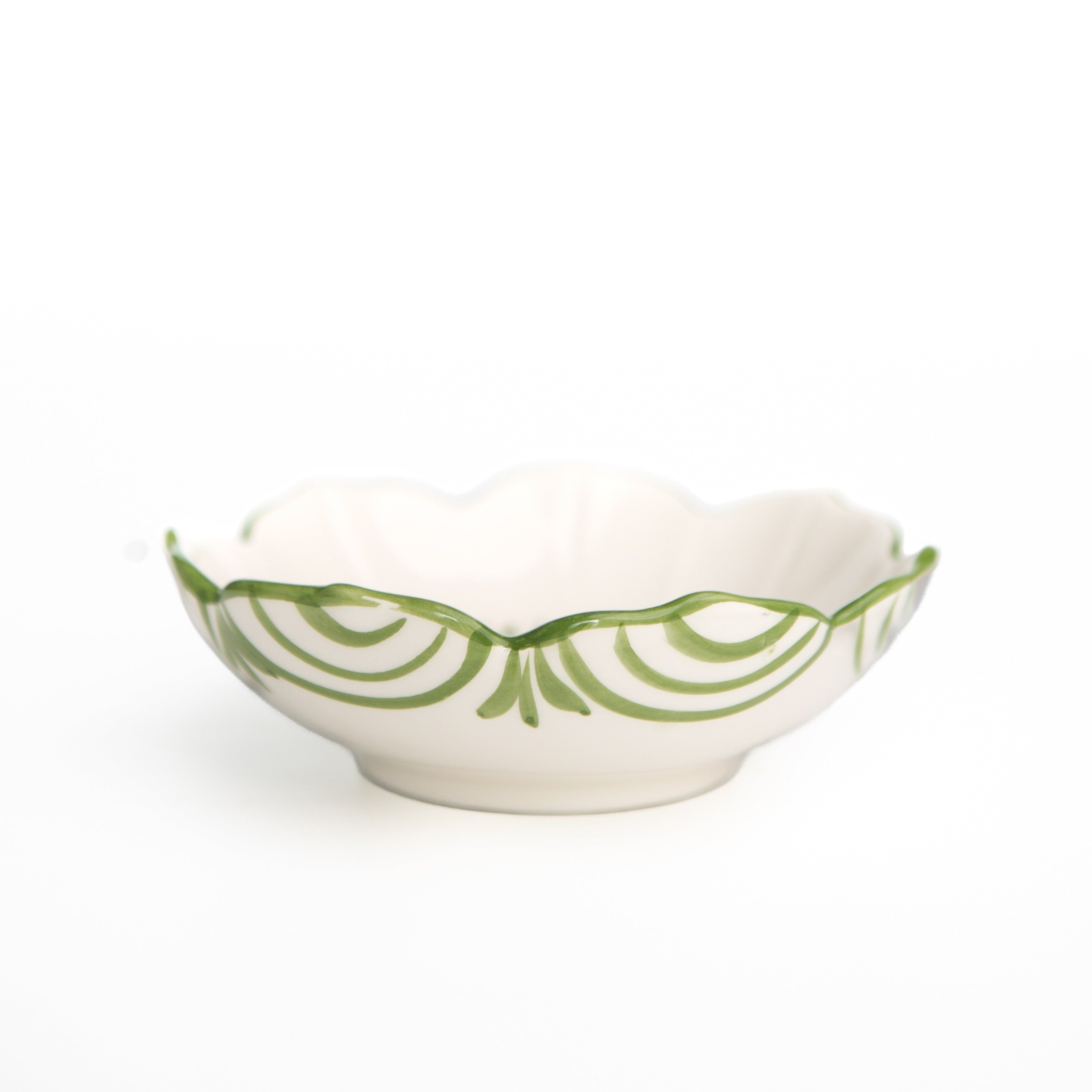 White bowl with green decorative pattern on a white background