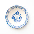 Ceramic serving bowl with blue floral and pomegranate design on a white background
