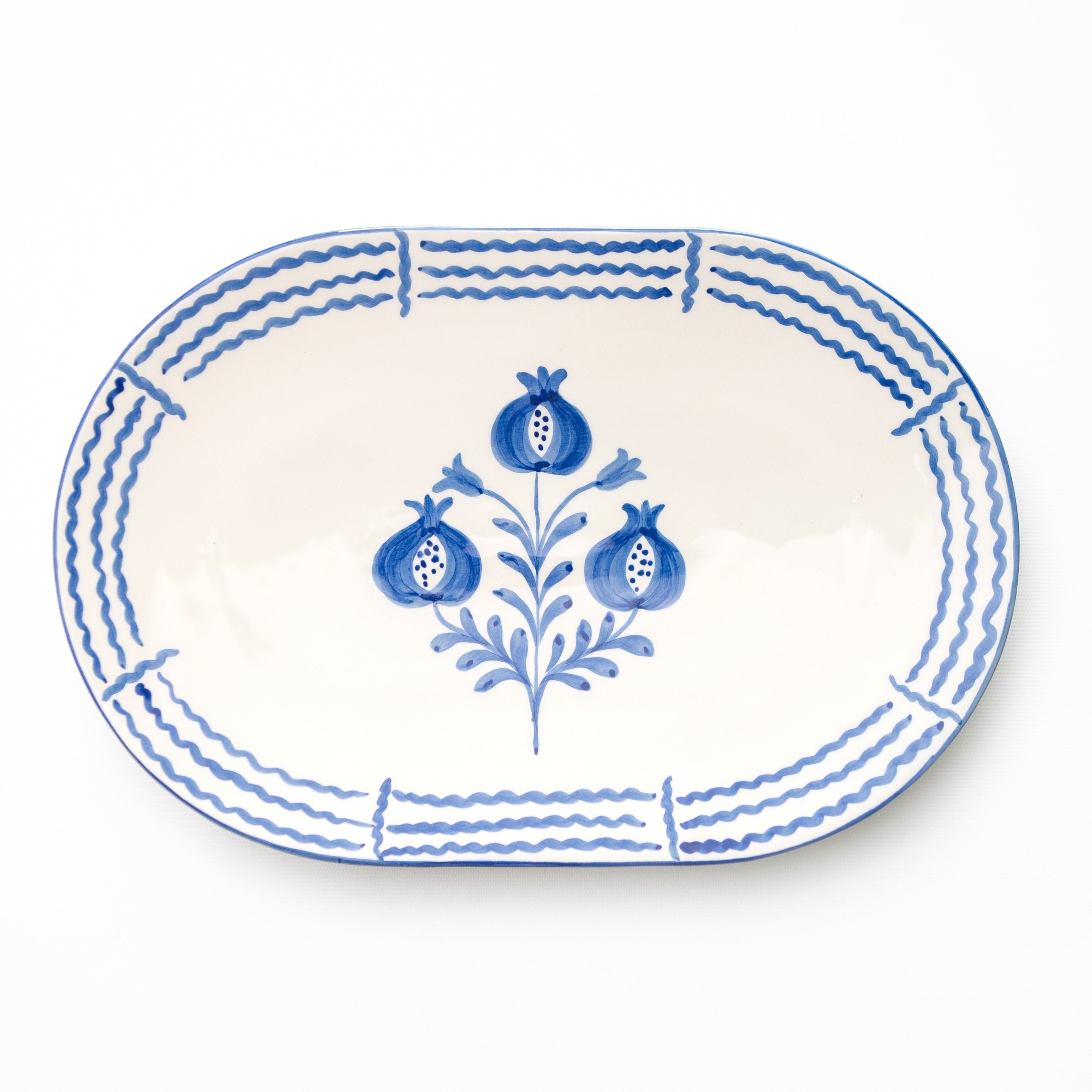 Oval ceramic platter with blue floral design on a white background