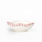 White ceramic bowl with red decorative rim on a white background
