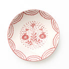 Decorative serving bowl with floral and pomegranate pattern on a white background