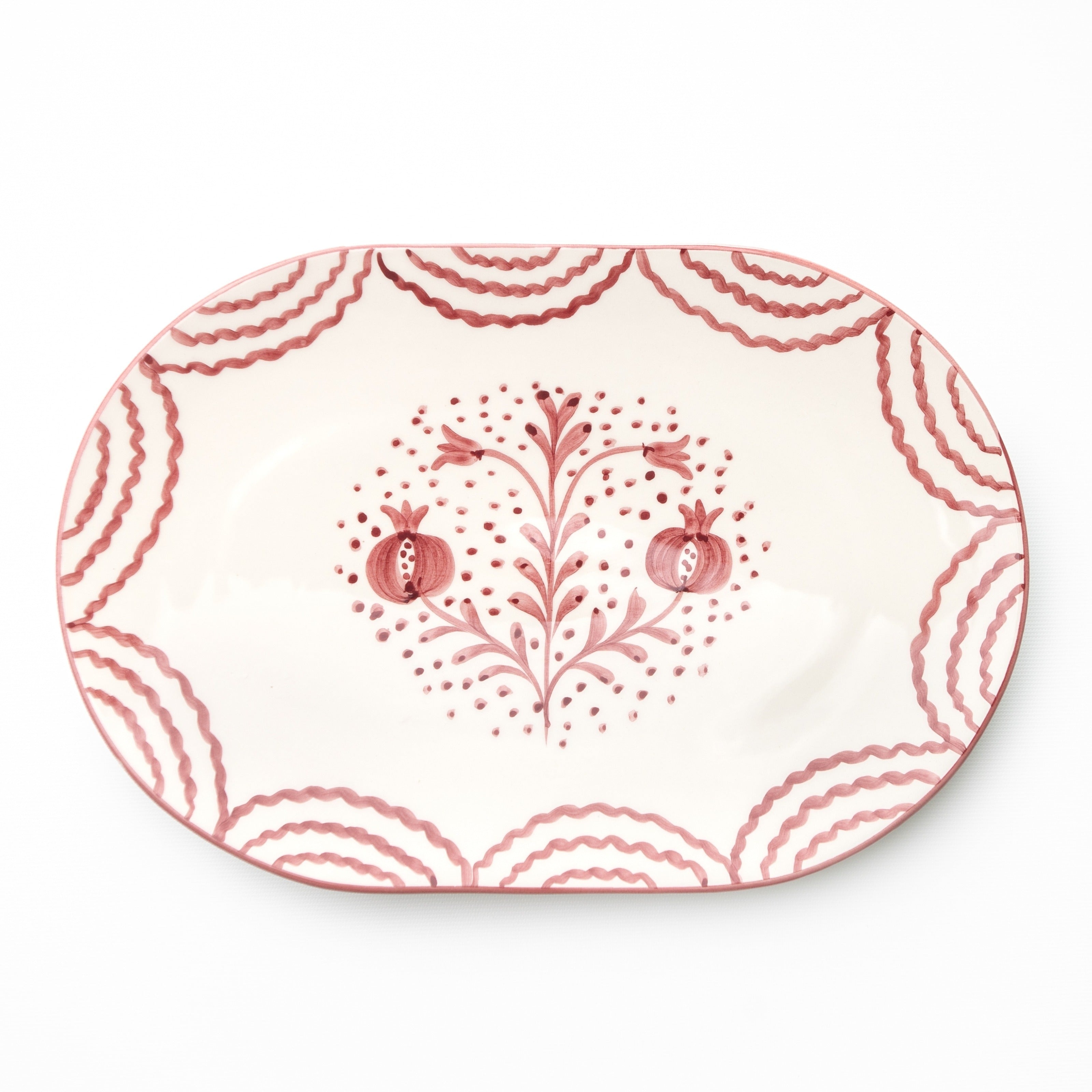 Decorative platter with pink floral design on a white background