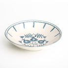 Ceramic serving bowl with blue floral design on a white background