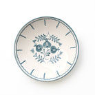 Ceramic serving bowl with blue floral design on a white background