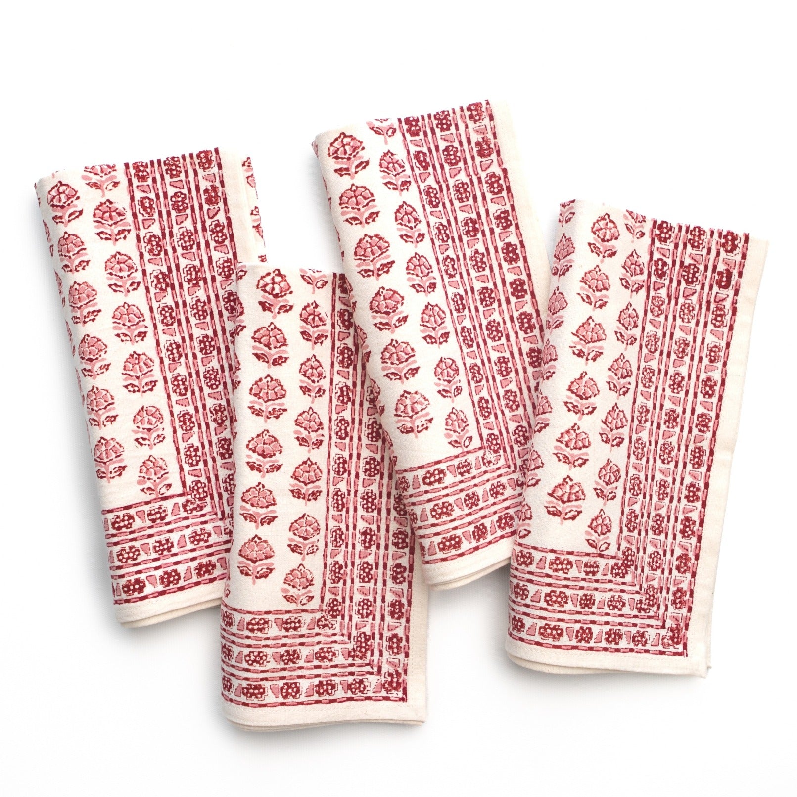 Set of four white towels with red floral patterns on a white background