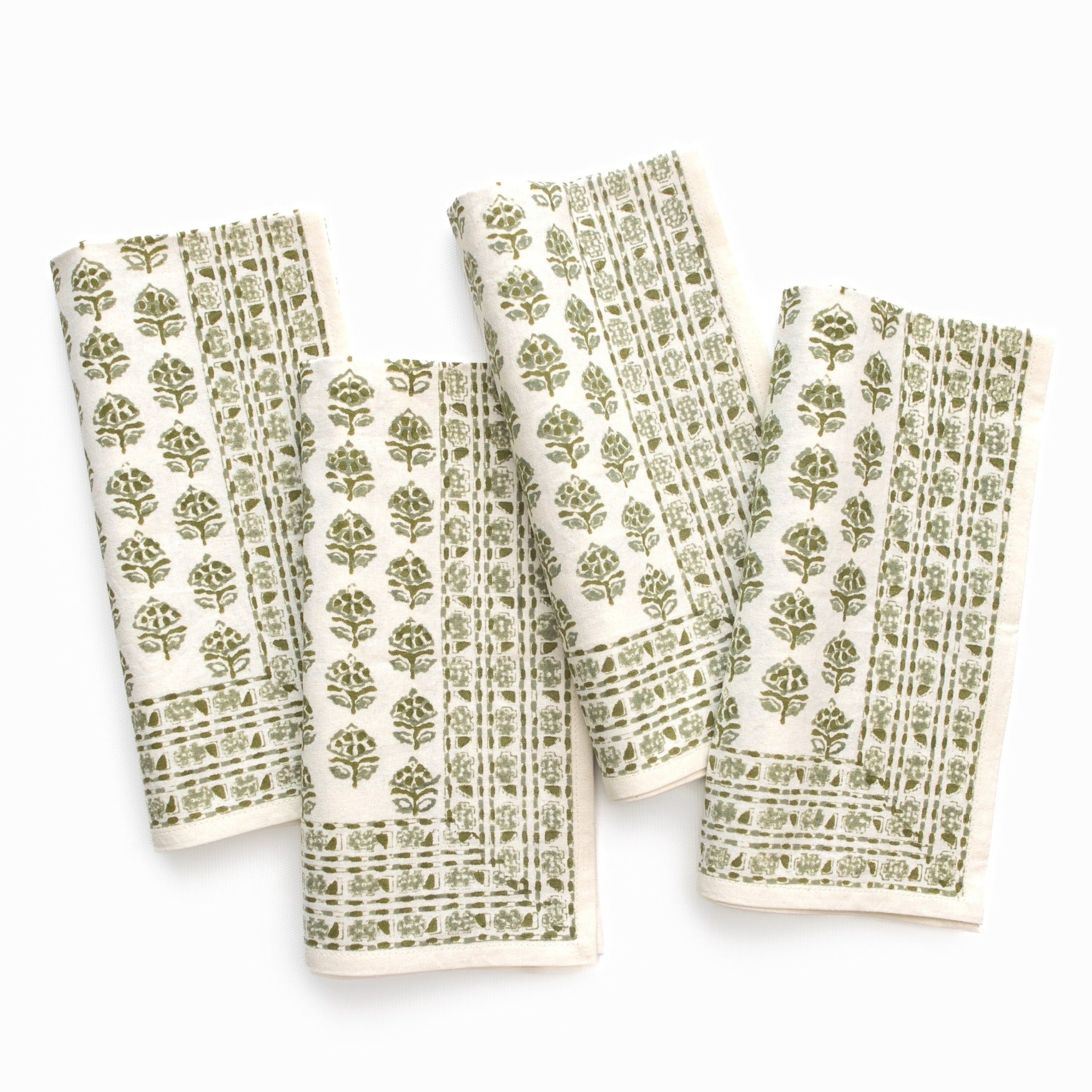Set of four patterned towels with green designs on a white background