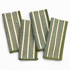 Set of four green and white striped towels on a white background