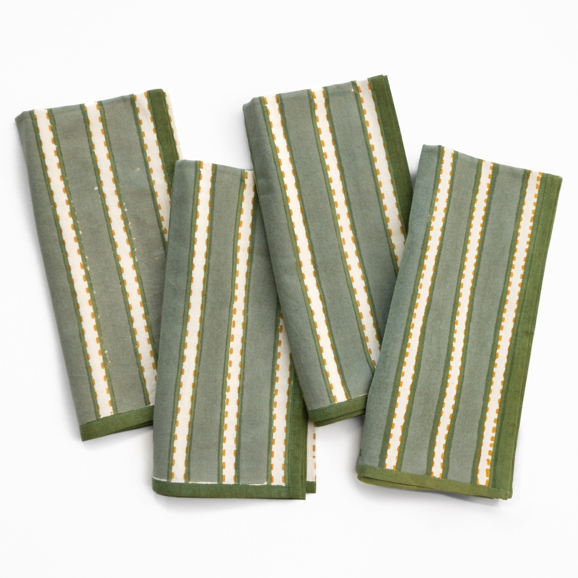 Set of four green and white striped towels on a white background