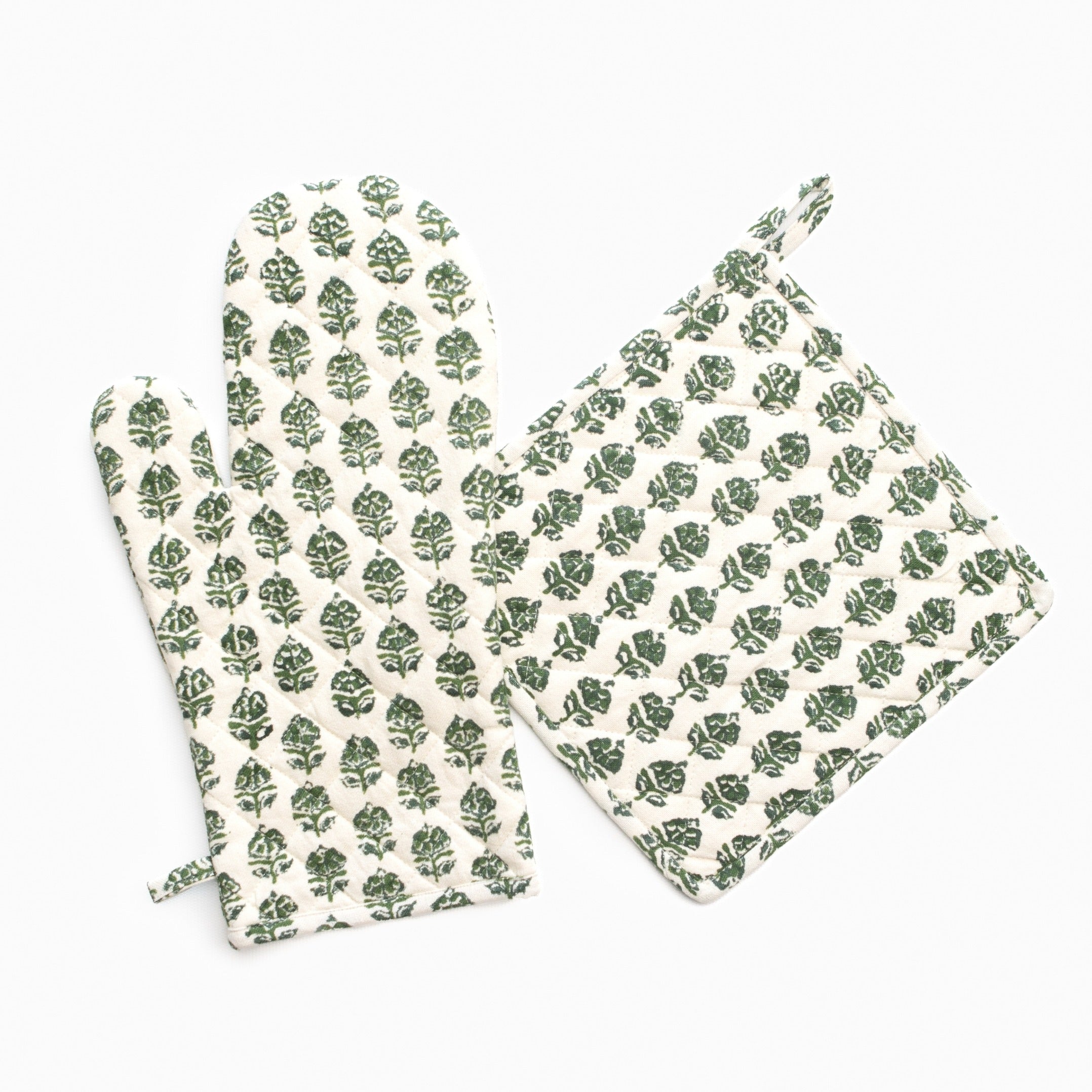 Set of green leaf-patterned pot holder and oven mitt on a white background