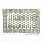 Green patterned placemat with white border on a white background
