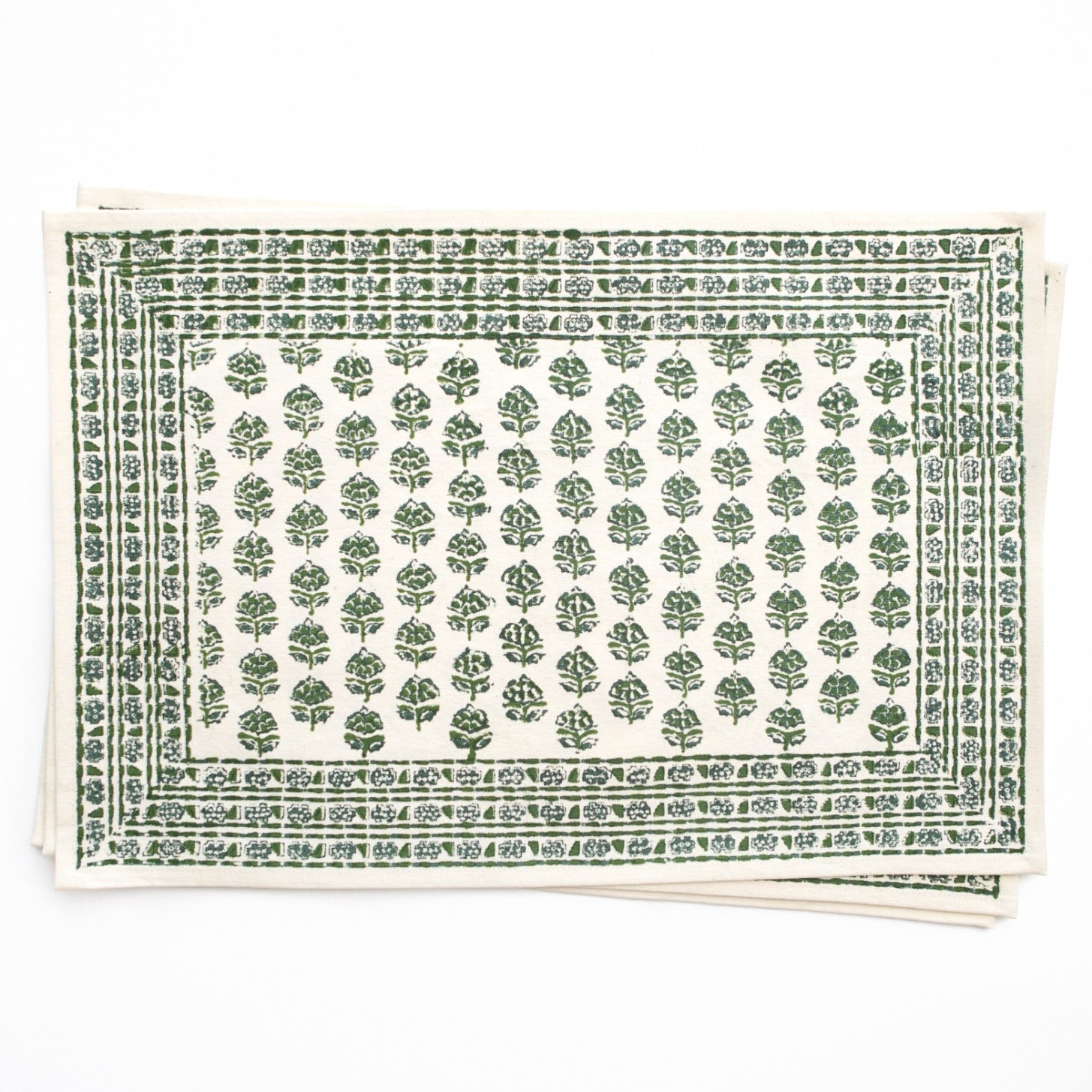 Green patterned placemat with white border on a white background