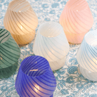 Lamps with a conical shade placed on a patterned surface.