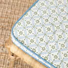 Patterned fabric cover on a wicker chair