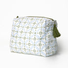 Cosmetic bag with geometric pattern and green tassel on a white background