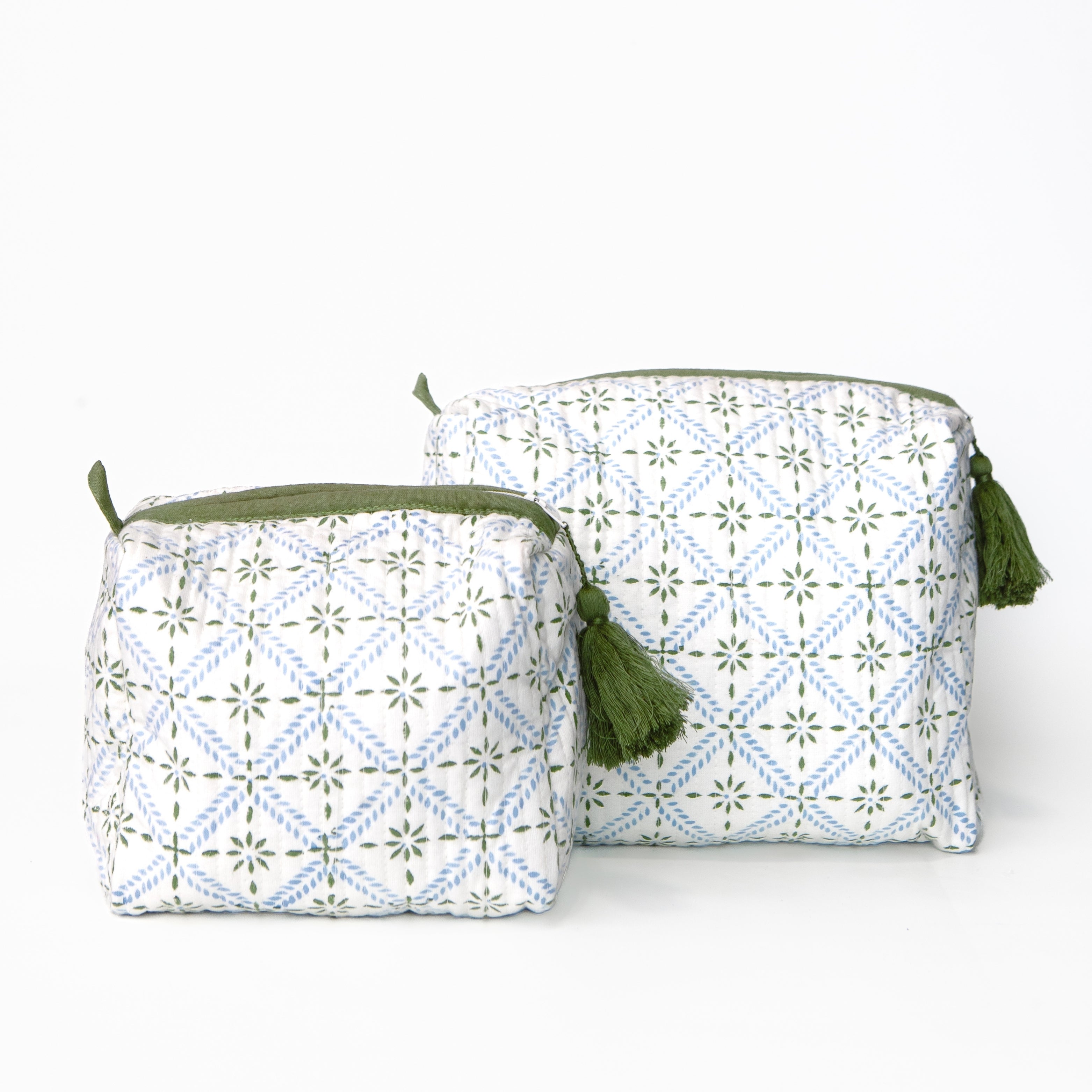 Two fabric pouches with green tassels on a white background