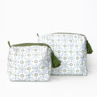 Two fabric pouches with green tassels on a white background