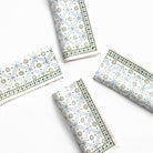 Four folded paper napkins with geometric patterns on a white background