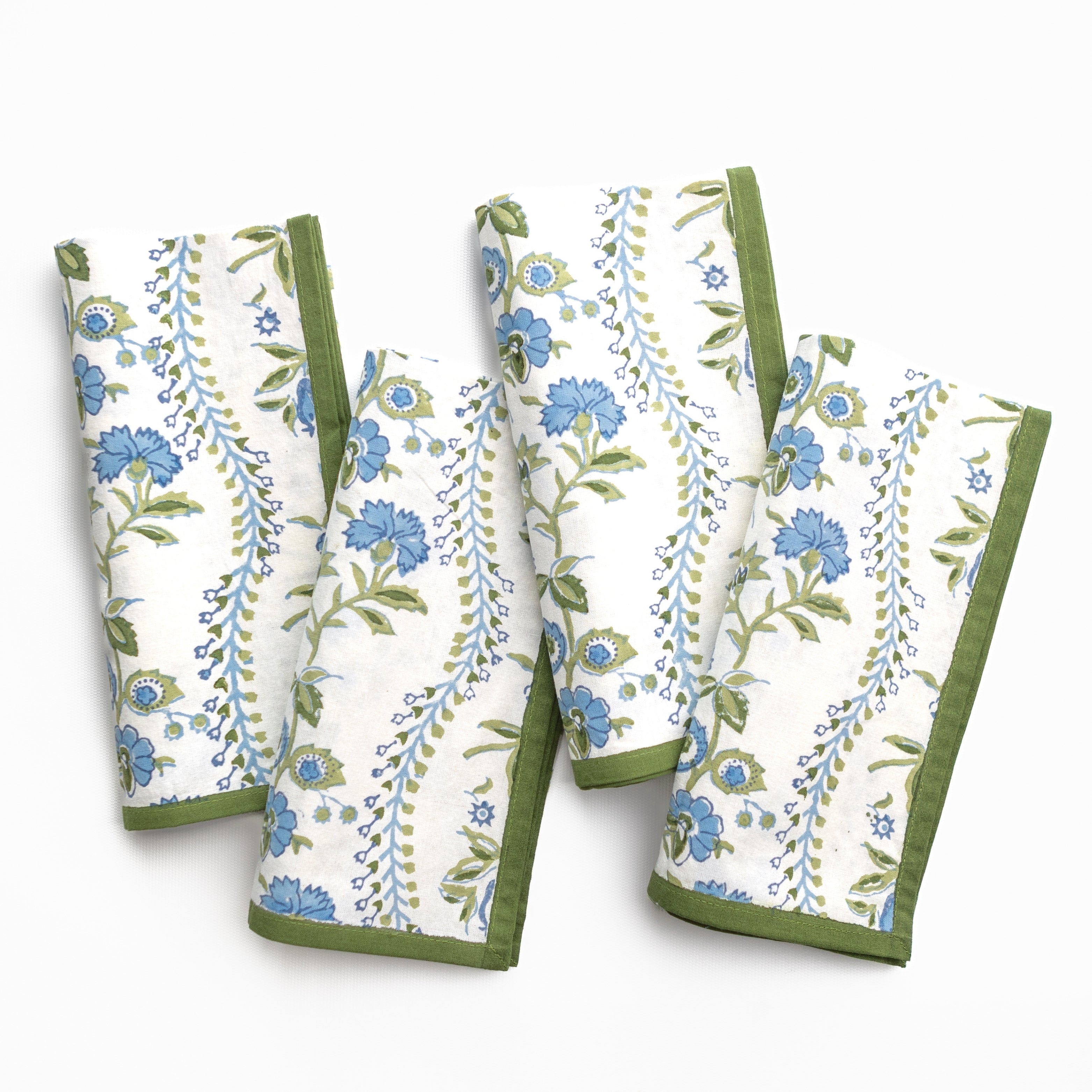 Set of four floral-patterned towels with green borders on a white background