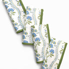Set of floral-patterned towels with green accents on a white background