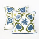 Two decorative pillows with floral pattern on a white background