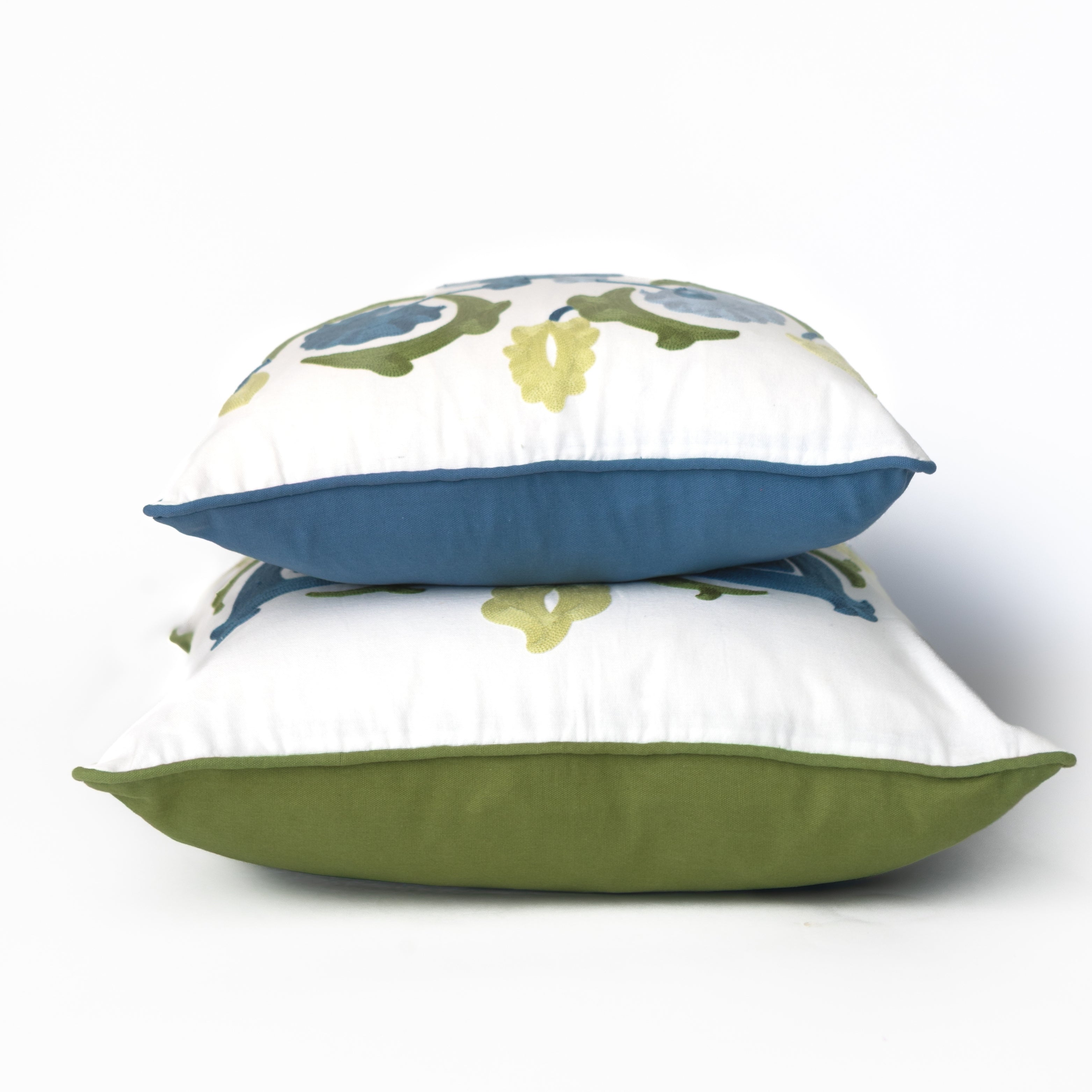 Three decorative pillows with floral patterns on a white background