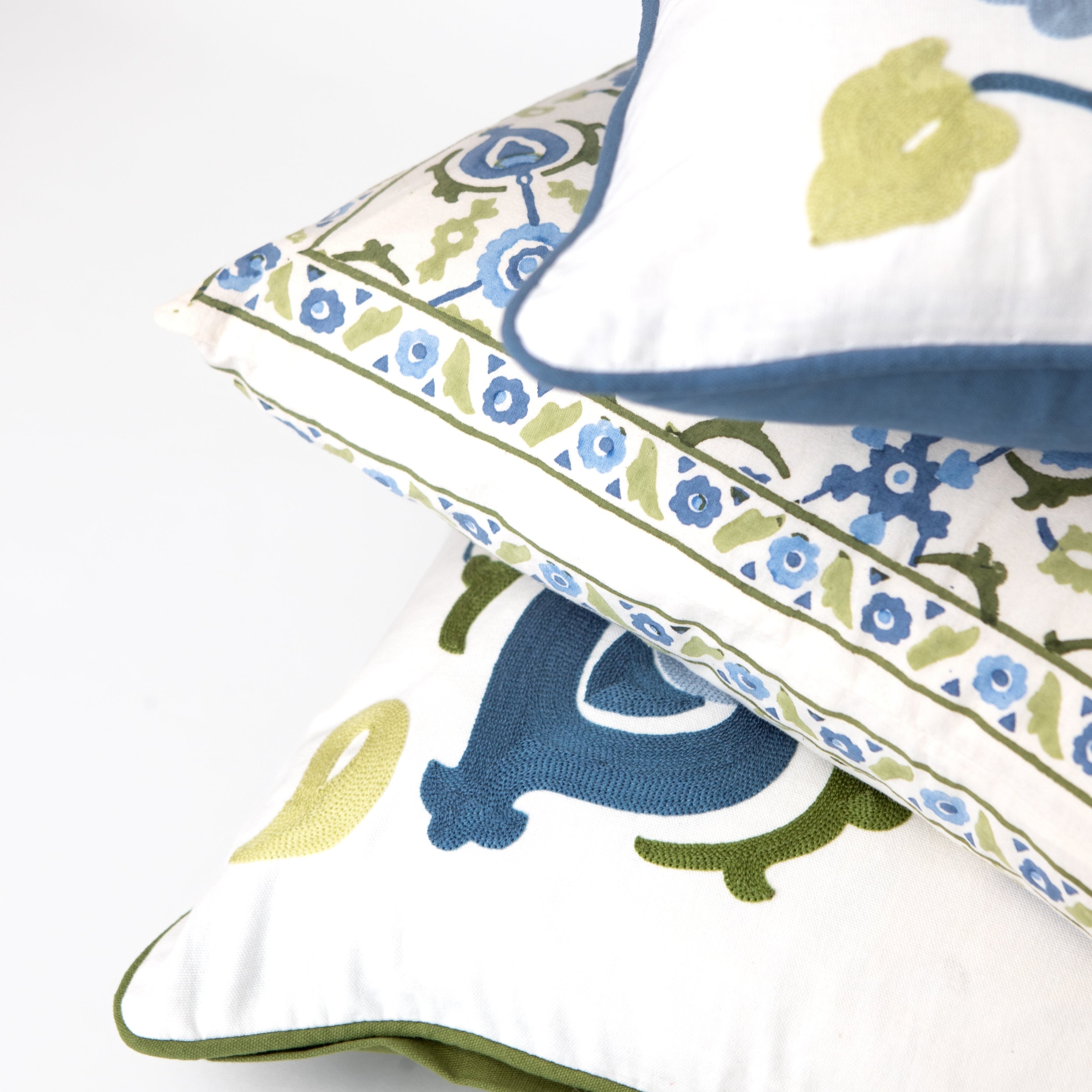 Decorative pillows with floral patterns on a white background