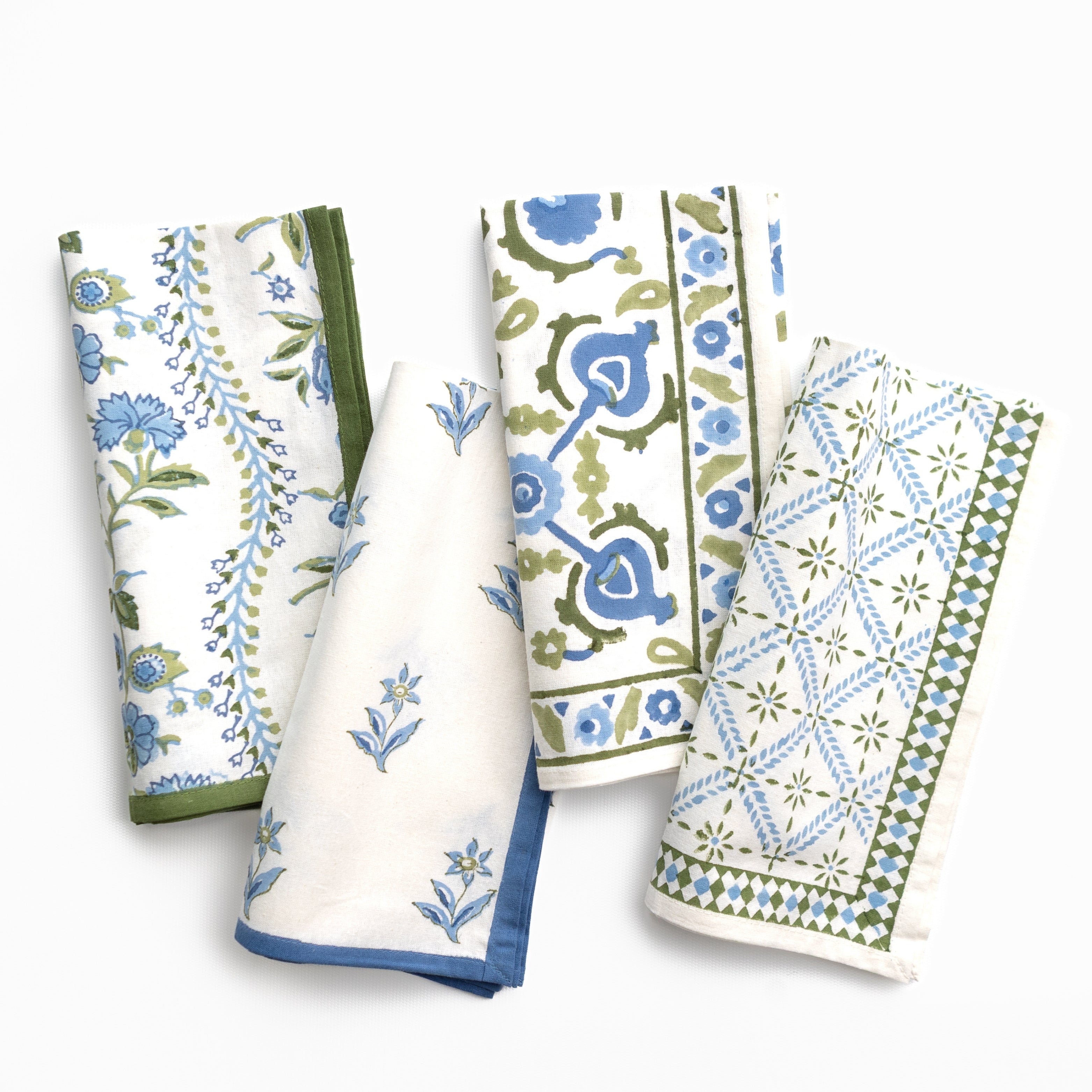 Set of four patterned napkins on a white background