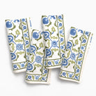 Set of four floral patterned napkins on a white background