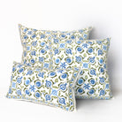 Three decorative pillows with a blue and green pattern on a white background