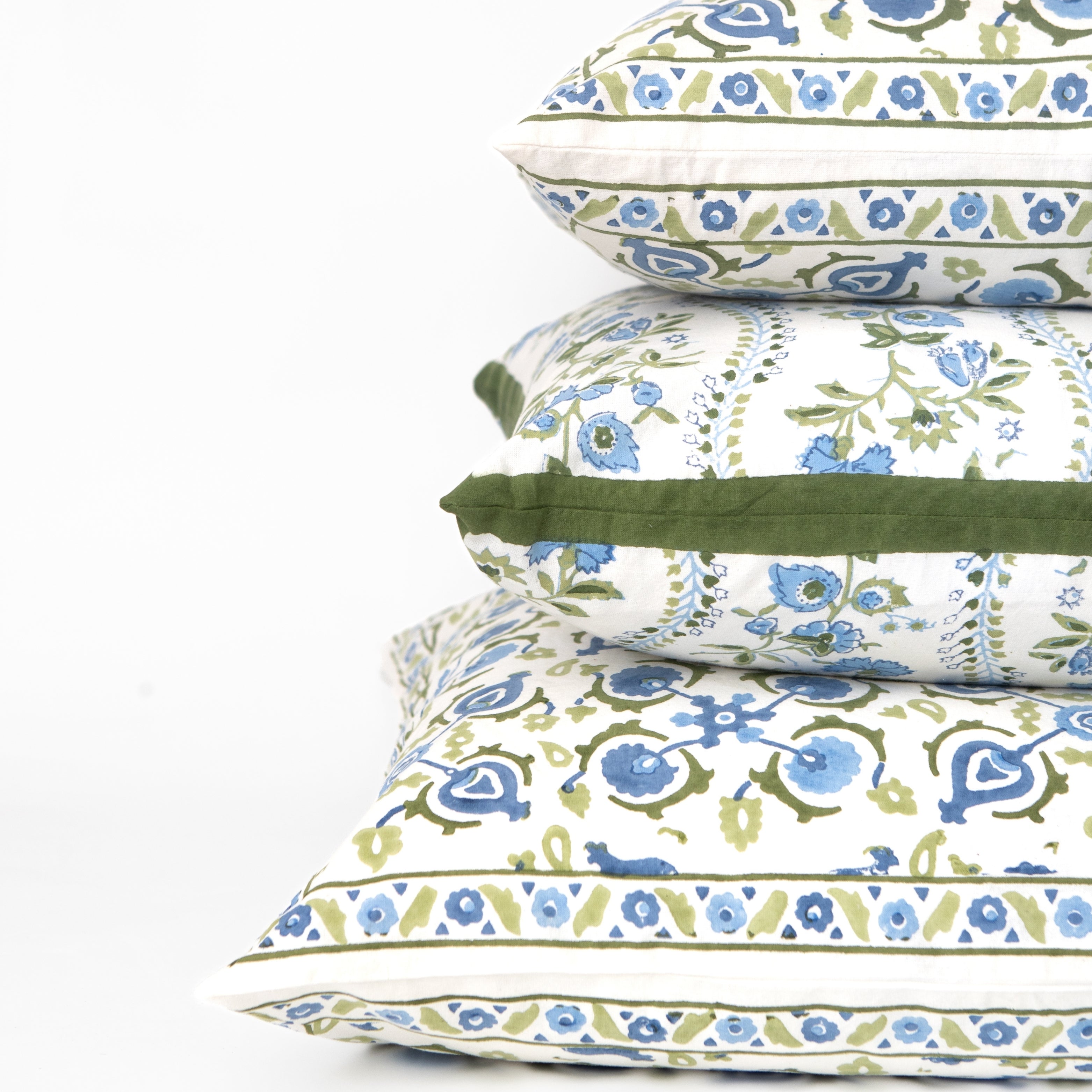 Stack of floral-patterned pillows on a white background