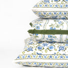 Stack of floral-patterned pillows on a white background