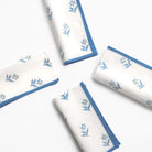 Set of white napkins with blue floral patterns on a white background