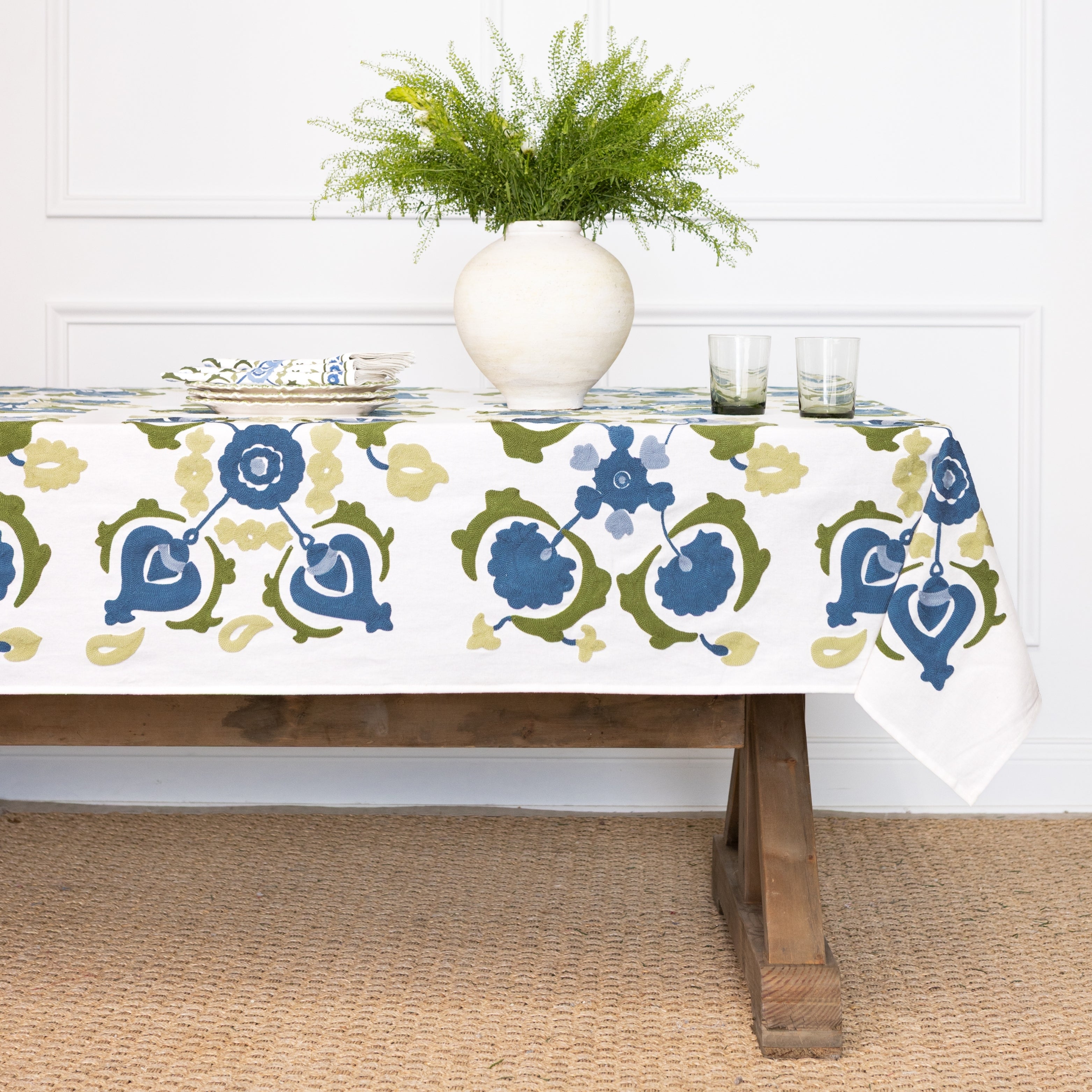 Tablecloth with blue and green floral pattern on a wooden table